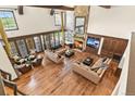 Elegant living room featuring a stone fireplace, hardwood floors, and lots of seating at 7390 Sagebrush Dr, Parker, CO 80138