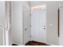Bright entryway featuring white doors, and dark hardwood floors, creating a clean and inviting space at 5540 Palomino Way, Frederick, CO 80504