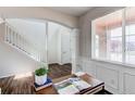 Elegant foyer with white trim, hardwood floors, and natural light creating a bright and airy entrance at 5540 Palomino Way, Frederick, CO 80504