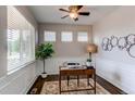 Cozy office space with natural light, stylish decor, and hardwood floors perfect for remote work at 5540 Palomino Way, Frederick, CO 80504