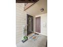 Charming condo entryway with 'HOME' welcome mat and tasteful decor at 7710 W 87Th Dr # K, Arvada, CO 80005