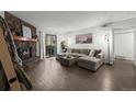Cozy living room with a stone fireplace and large sectional sofa at 7710 W 87Th Dr # K, Arvada, CO 80005