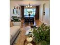 Inviting dining room with a large window, modern chandelier, and comfortable seating for six at 4196 S Reading Way, Denver, CO 80237