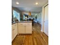 Bright and modern kitchen featuring white cabinets, stainless steel appliances, and a view of the Gathering room at 4196 S Reading Way, Denver, CO 80237