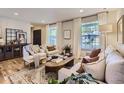 Bright and inviting living room with hardwood floors, stylish decor, and ample natural light at 4196 S Reading Way, Denver, CO 80237