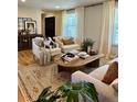 Bright living room featuring stylish furniture, a patterned rug, and lots of natural light at 4196 S Reading Way, Denver, CO 80237