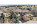 Charming two-story house with a three-car garage, well-maintained lawn, and inviting curb appeal at 16323 River Haven Way, Morrison, CO 80465