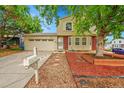 Charming two-story home with attached garage and manicured front yard at 4848 S Pitkin Way, Aurora, CO 80015