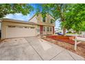 Charming two-story home with attached garage and long driveway at 4848 S Pitkin Way, Aurora, CO 80015