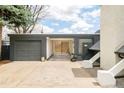 Attached carport and garage with gray doors and adjacent landscape elements at 1884 S Ivy St, Denver, CO 80224