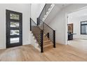 Light and airy entryway with modern staircase and hardwood floors at 3289 S Eudora St, Denver, CO 80222