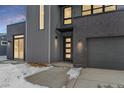 Modern home exterior with gray siding, and a walkway leading to the front door at 3289 S Eudora St, Denver, CO 80222