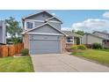 Charming two-story home with a brick and siding exterior and an attached two-car garage at 6017 S Pierson St, Littleton, CO 80127