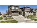 Stunning exterior showcasing the home's architecture, landscaping, and mountain views in the distance at 16345 Spanish Peak Way, Broomfield, CO 80023