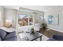 Sunlit living room featuring a large window, plush seating, and tasteful decor, creating an inviting atmosphere at 2624 N Clay St, Denver, CO 80211