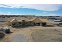 A new build home with a partial roof and visible framing, set on a spacious lot with beautiful countryside in the background at 1286 Lisbon Dr, Parker, CO 80138