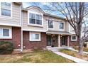 Charming townhome exterior with brick and siding, manicured lawn, and inviting front entrance at 18397 E Alabama Pl # D, Aurora, CO 80017