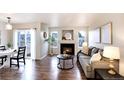 Inviting living room with hardwood floors, fireplace, and comfortable seating at 18397 E Alabama Pl # D, Aurora, CO 80017