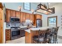 Modern kitchen with stainless steel appliances, wooden cabinets, and an island with seating at 400 Argentine St, Georgetown, CO 80444