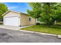Single Gathering home featuring a two car garage, grass lawn and mature landscaping at 7725 Hummingbird Green # 78, Frederick, CO 80530