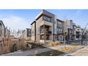 Modern three-story townhome with light gray and white exterior at 1415 W 68Th Ave, Denver, CO 80221