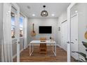 Bright home office with a desk, two guitars, and plenty of natural light at 1415 W 68Th Ave, Denver, CO 80221