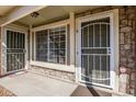 The entrance with secure doors and a small concrete patio at 1885 S Quebec Way # A16, Denver, CO 80231