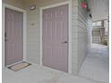 Apartment hallway with side-by-side doors and a 'Welcome' mat, leading to an outdoor staircase at 12896 Ironstone Way # 203, Parker, CO 80134