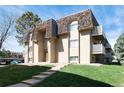Inviting apartment complex with well-maintained landscaping and charming architectural details at 7455 E Quincy Ave # 204, Denver, CO 80237