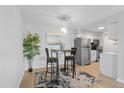 This kitchen features stainless steel appliances, a small table for eating, and wood-look floors at 7455 E Quincy Ave # 204, Denver, CO 80237