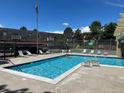 Community pool with lounge chairs, perfect for relaxation and recreation at 7455 E Quincy Ave # 204, Denver, CO 80237