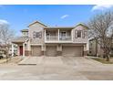 Attractive townhome featuring a two-car garage, balcony, and inviting curb appeal on a bright day at 13023 Grant Cir # C, Thornton, CO 80241