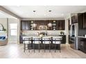 Modern kitchen featuring stainless steel appliances, granite countertops, an island with bar seating at 11100 Pastel Pt, Parker, CO 80134