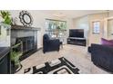 Inviting living room with a cozy fireplace, plush seating, and a large window offering natural light at 4121 W 111Th Cir, Westminster, CO 80031