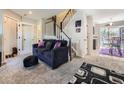 Comfortable living room leading to the stairs and kitchen with open floor plan at 4121 W 111Th Cir, Westminster, CO 80031