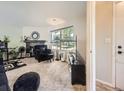 Spacious living room featuring a fireplace, plush seating, large window and neutral carpet at 4121 W 111Th Cir, Westminster, CO 80031