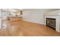 Spacious living room with hardwood floors, fireplace, and an open view to the kitchen at 3006 W 107Th Pl # D, Westminster, CO 80031