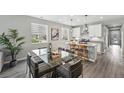 Bright dining area with a glass-top table and modern decor, adjacent to the kitchen at 1592 Maggie Mae Ln, Castle Rock, CO 80104