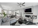Contemporary living room featuring a sleek fireplace, recessed lighting, and an open-concept design at 1592 Maggie Mae Ln, Castle Rock, CO 80104