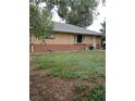 Attractive brick home with a tidy front lawn and an inviting exterior at 6911 Weiman Ct, Commerce City, CO 80022