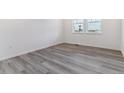 Bright bedroom with large windows, luxury vinyl plank flooring, and neutral color palette at 25254 E Warren Pl, Aurora, CO 80018