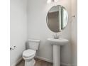 The home features a powder room with modern pedestal sink and an oval mirror at 4464 Boone Cir, Brighton, CO 80601