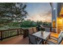 Outdoor dining on the deck with a table, chairs, grill, and a view of the green landscape at 5048 Rocky Mountain Dr, Castle Rock, CO 80109