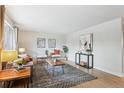 Cozy living room with hardwood floors, a patterned rug, and contemporary furniture at 8490 E Davies Pl, Centennial, CO 80112