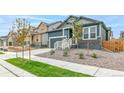 New construction two-story home with a two-car garage, landscaped front yard, and a welcoming entryway at 13342 E 110Th Way, Commerce City, CO 80022