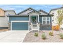 Charming blue two-story home with stone accents, a two-car garage, and well-maintained landscaping at 13342 E 110Th Way, Commerce City, CO 80022