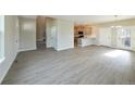 Open-concept living area with wood floors leading to a modern kitchen and dining area at 21854 E 9Th Pl, Aurora, CO 80018