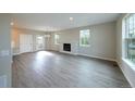 Spacious living room with wood floors, fireplace, and lots of natural light at 21854 E 9Th Pl, Aurora, CO 80018