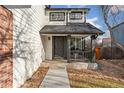 Inviting front entrance with a covered porch and walkway at 447 Woodson Dr, Erie, CO 80516