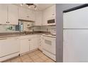 White kitchen with appliances and ample counter space at 2500 S York St # 107, Denver, CO 80210